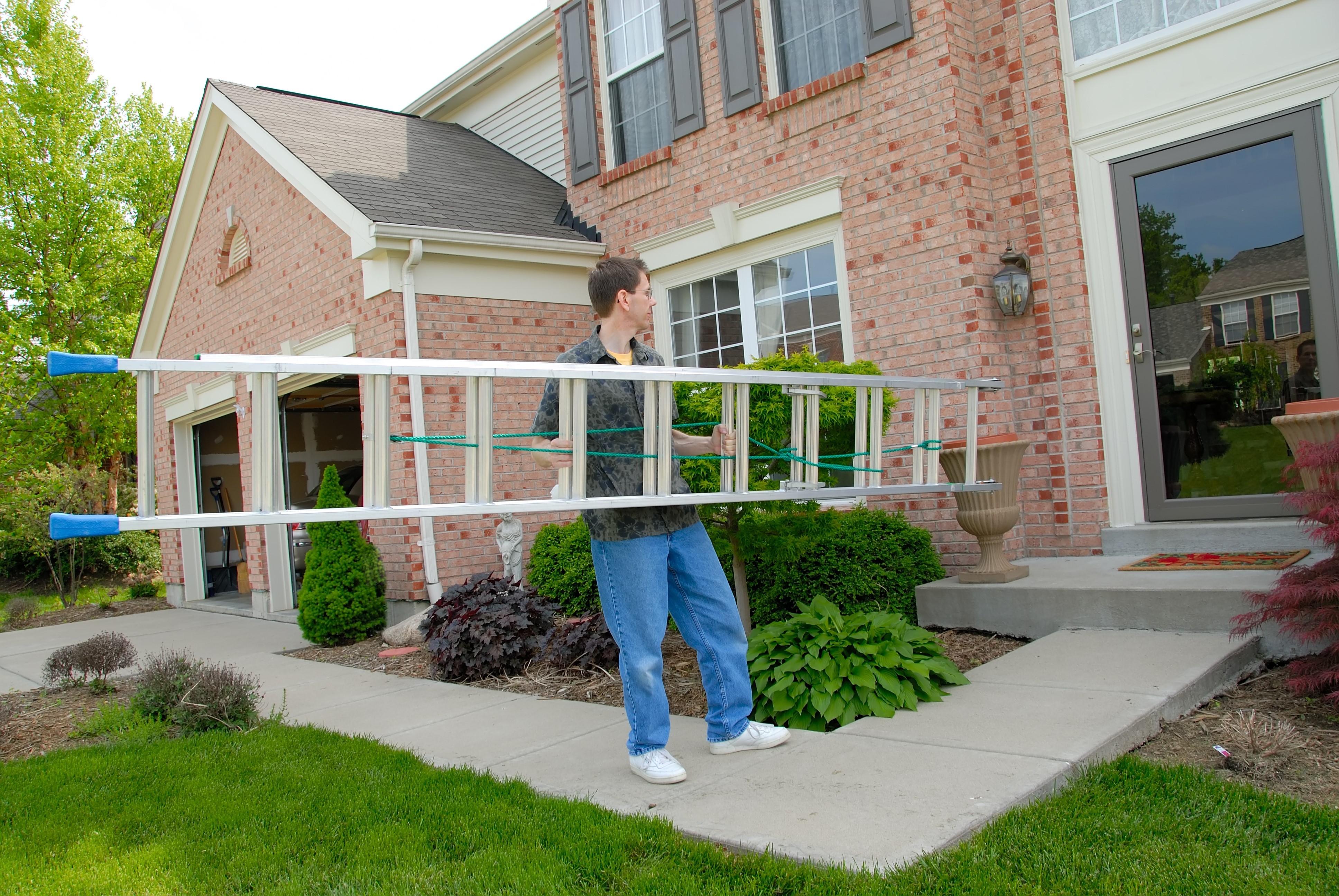 A Georgia resident carefully carries a ladder