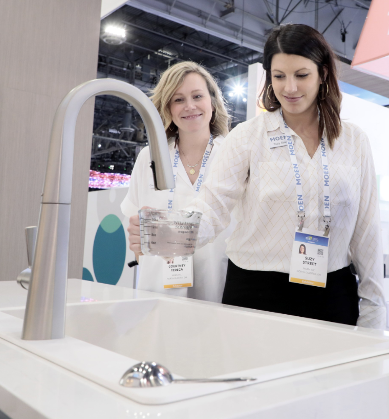 ladies looking at moen smart faucet