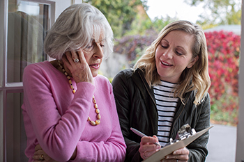 Female Sales Person Trying To Persuade Senior Woman To Purchase Goods Or Services